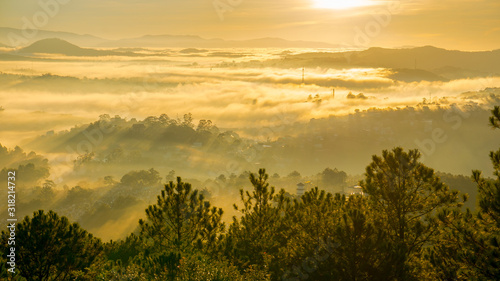 nice day in Da Lat, on the top of mountain view down of city in fog, sun light and rays