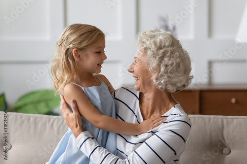 Wallpaper Mural Happy middle aged grandmother holding on lap cute small granddaughter. Torontodigital.ca
