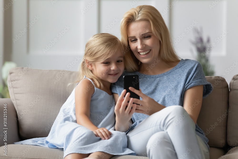 Cheerful two generations family watching video, taking selfie.