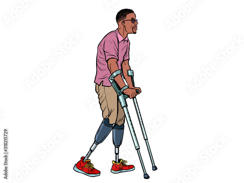 legless african veteran with a bionic prosthesis with crutches. a disabled man learns to walk after an injury. rehabilitation treatment and recovery