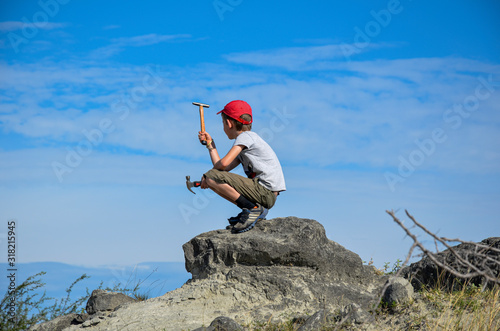 boy at the top of a hill in the Tatacoa desert looking for treasures