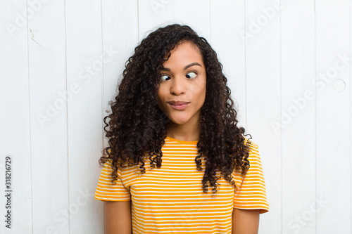 young latin woman looking goofy and funny with a silly cross-eyed expression, jo фототапет