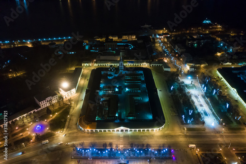 Red shopping arcades on Susaninskaya Square in the center of the ancient city of Kostroma at winter night, Russia photo