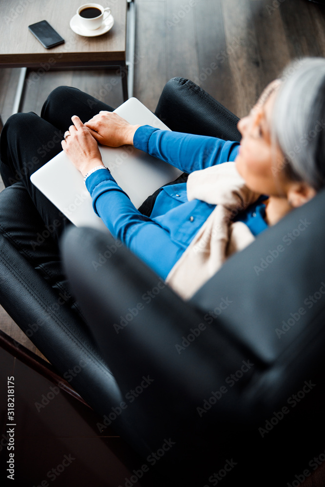 Top view of laptop on the knees of woman stock photo Top view of laptop on the knees of woman stock photo
