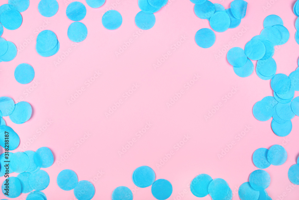 Blue confetti on pink background. Flat lay, top view. Copy space for text.