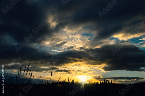 Sunset Landscape with Sun and Dark Clouds