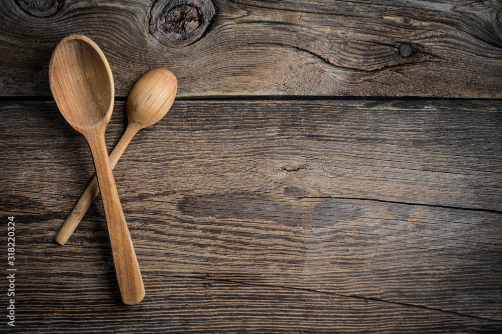 Wooden kitchen utensils on a wooden background. Copy space. Top view. Wooden kitchen utensils on a wooden background. Copy space. Top view.