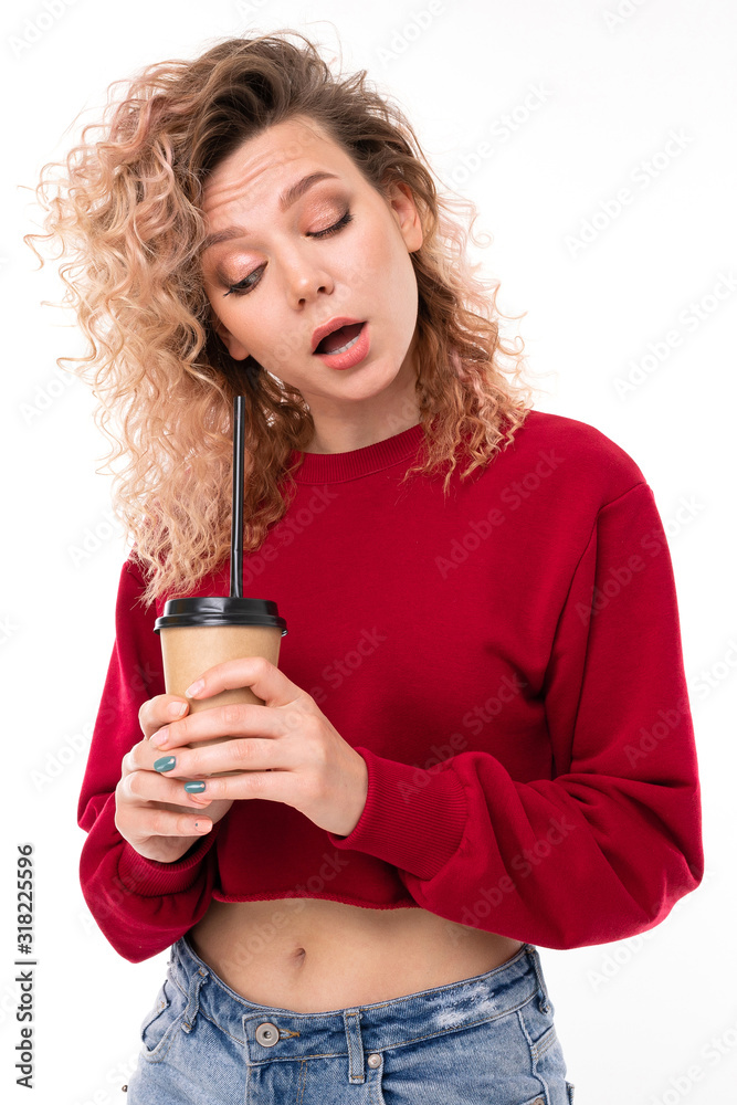 Handsome caucasian female with curly fair hair drinks coffe isolated on white background Handsome caucasian female with curly fair hair drinks coffe isolated on white background