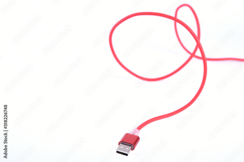 Red USB cable for smartphone charge isolated on white background. Red USB cable for smartphone charge isolated on white background.