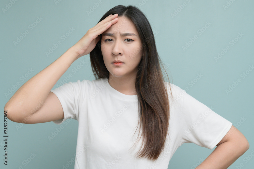 Exhausted Caucasian woman isolated on blue studio background touch massage temples suffer from strong migraine and fever. Exhausted Caucasian woman isolated on blue studio background touch massage temples suffer from strong migraine and fever.
