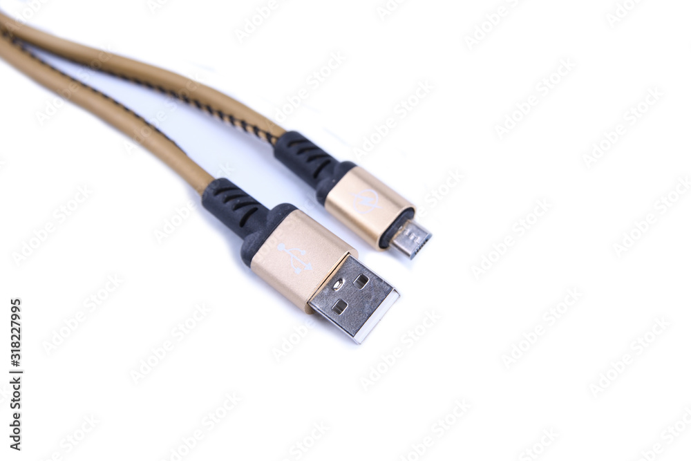 Folded USB lightning charging smartphone golden cable isolated over the white background Folded USB lightning charging smartphone golden cable isolated over the white background