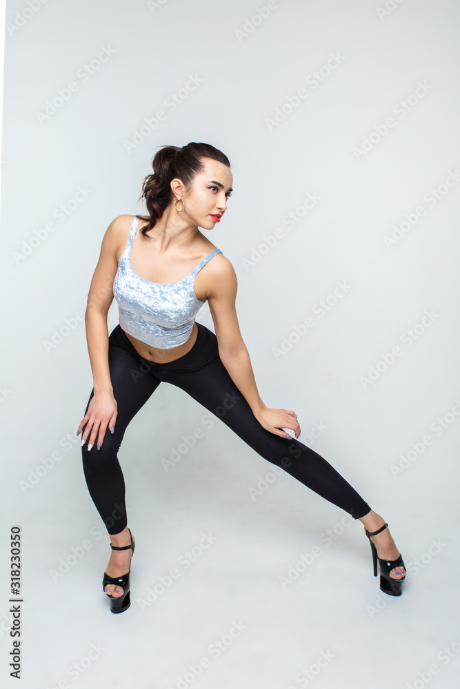 Beautiful and slender dancer girl in high heels