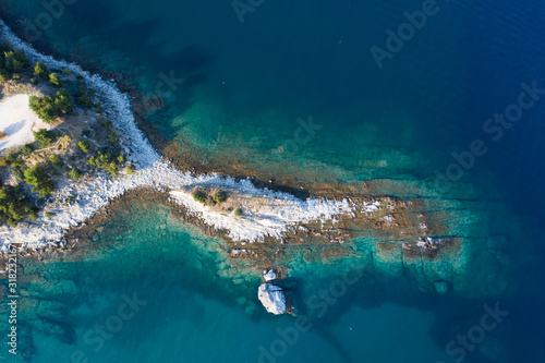 Aerial drone view of a remote rocky peninsula in Greece.