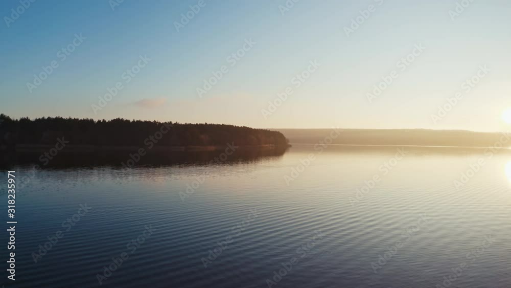 Evening river among nature.Tree without leaves over the water at sunset. Dark forest near the lake. Evening river among nature.Tree without leaves over the water at sunset. Dark forest near the lake.