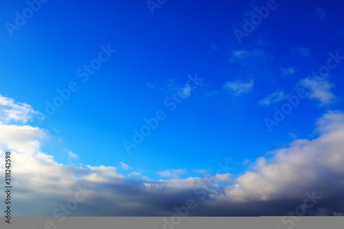 Blue sky with large clouds and sunlight. Nature background.