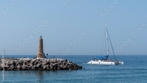 Wallpaper Mural marbella marina with a catamaran an a small lighthouseon the sea, spain Torontodigital.ca