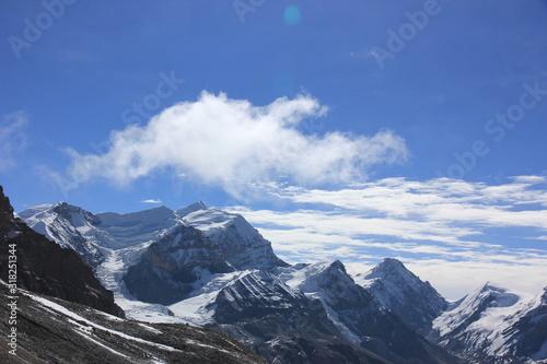 Snowy mountains against the blue sky with white clouds. Mountains of Nepal © Tetiana
