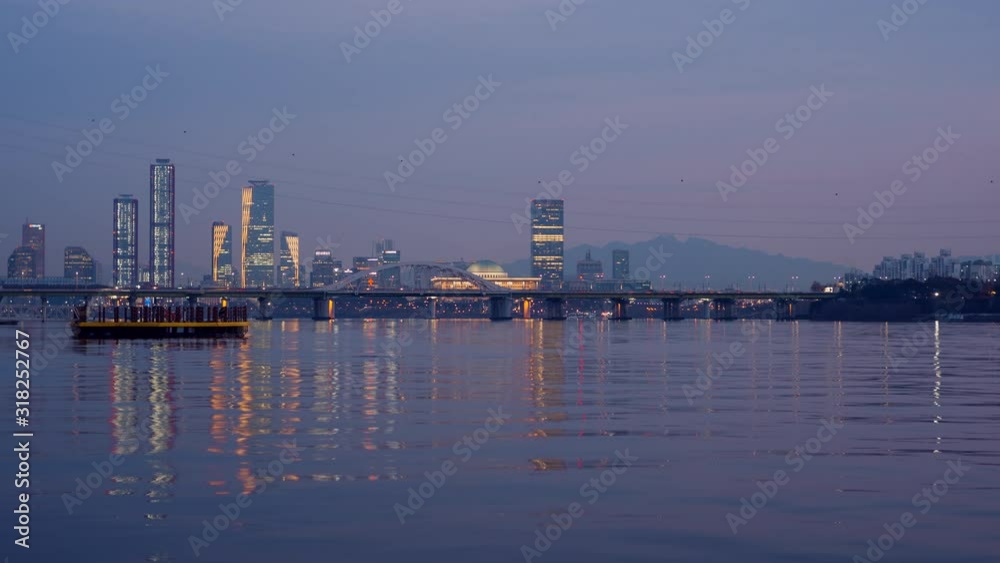 Time lapse of downtown of city with turning on the light by riverside at the sunset time in Yeouido, Seoul, Korea.