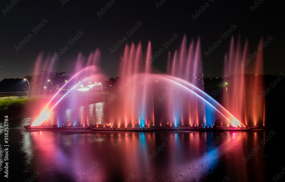 Night show of color fountains. Beautiful fountain show. Dancing fountain at Lantan Scenic Area in Taiwan