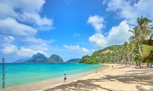 "Marimegmeg Beach" with shallow water and tiny offshore Island in El Nido on Palawan - Philippines.