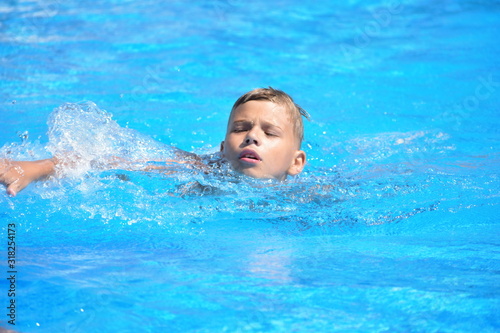 Little boy and watersports. Active holiday in the pool. swim practice © Victoria