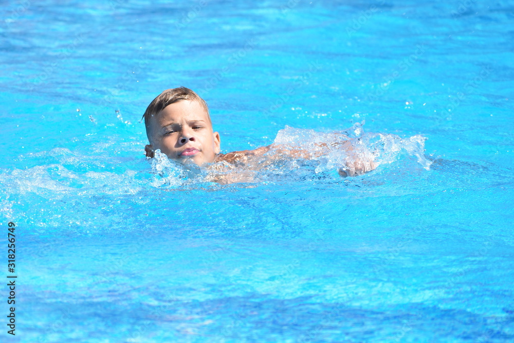 Little boy and watersports. Active holiday in the pool. swim practice