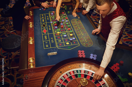 People gambling at roulette poker in a casino.