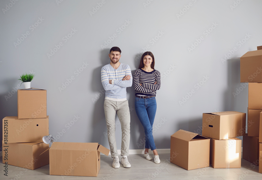 Young couple family with boxes to move in a new house room. Young couple family with boxes to move in a new house room.
