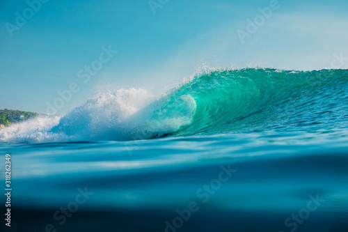 Barrel wave in sea. Blue wave with sun light