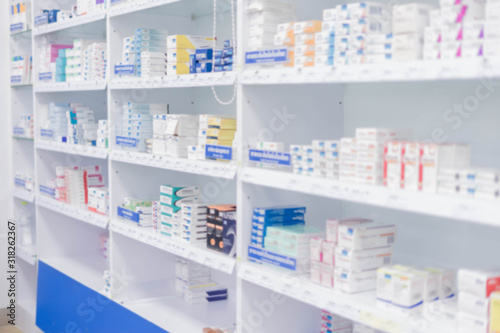 Medicines arranged in shelves, Pharmacy drugstore retail Interior blur abstract backbround with healthcare product on medicine cabinet. photo