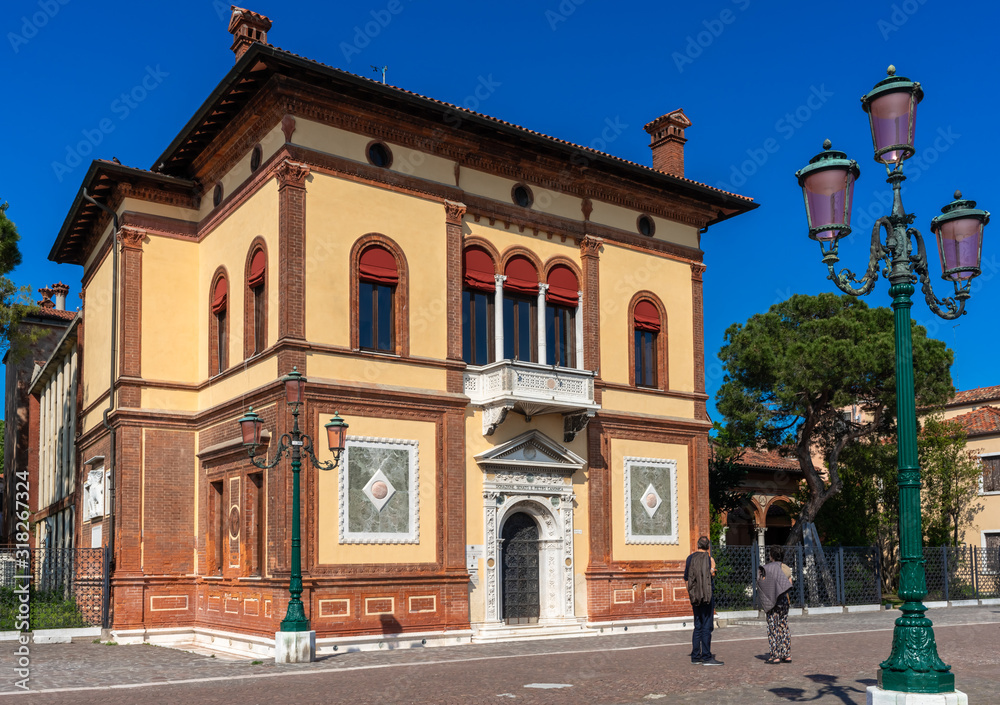 Venice. An ancient bright colored buildings, venetian palazzo. Vintage street lamp. Authentic architecture details. View of old european city on blue sky background. Travel tourism vacation in Italy.
