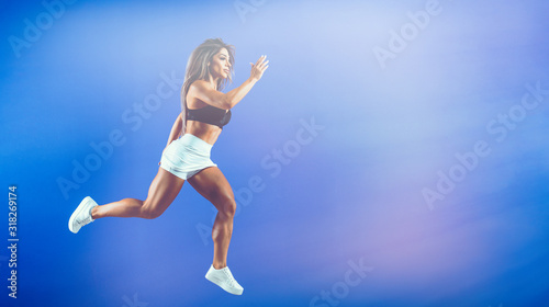 Wallpaper Mural Beautiful Fit Sporty Women Jump In The Air Torontodigital.ca