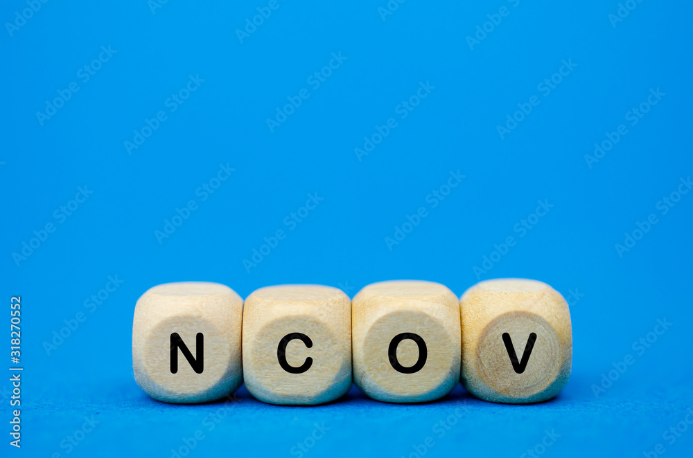 The inscription nCoV on wooden cubes, blue background. Health concept, Chinese 2019 virus ncov