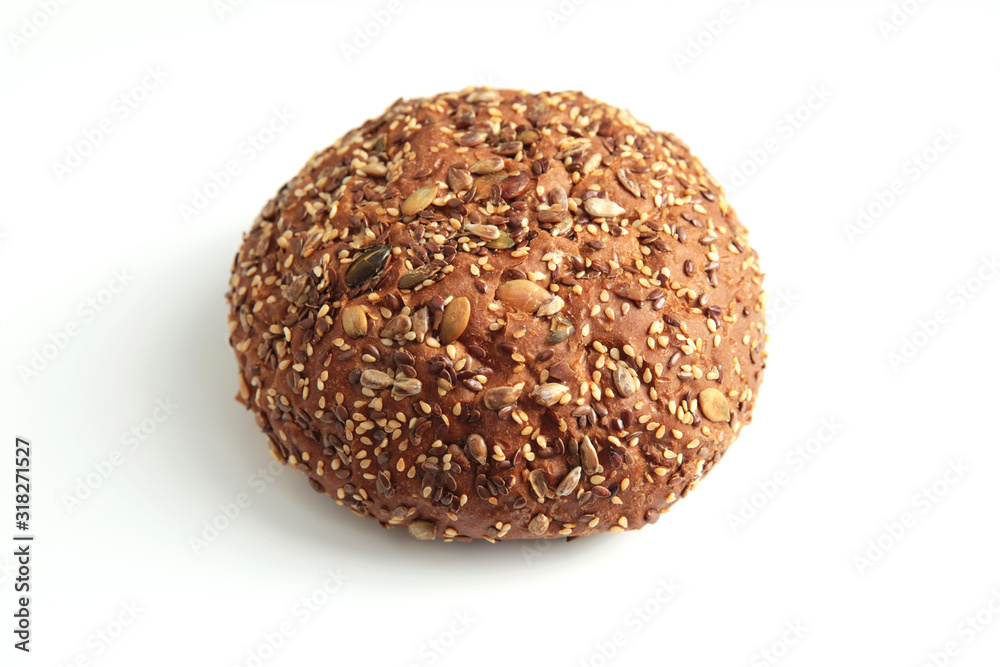 Traditional homemade french round bread isolated on a white background. Bread with sunflower and flax seeds. Traditional homemade french round bread isolated on a white background. Bread with sunflower and flax seeds.