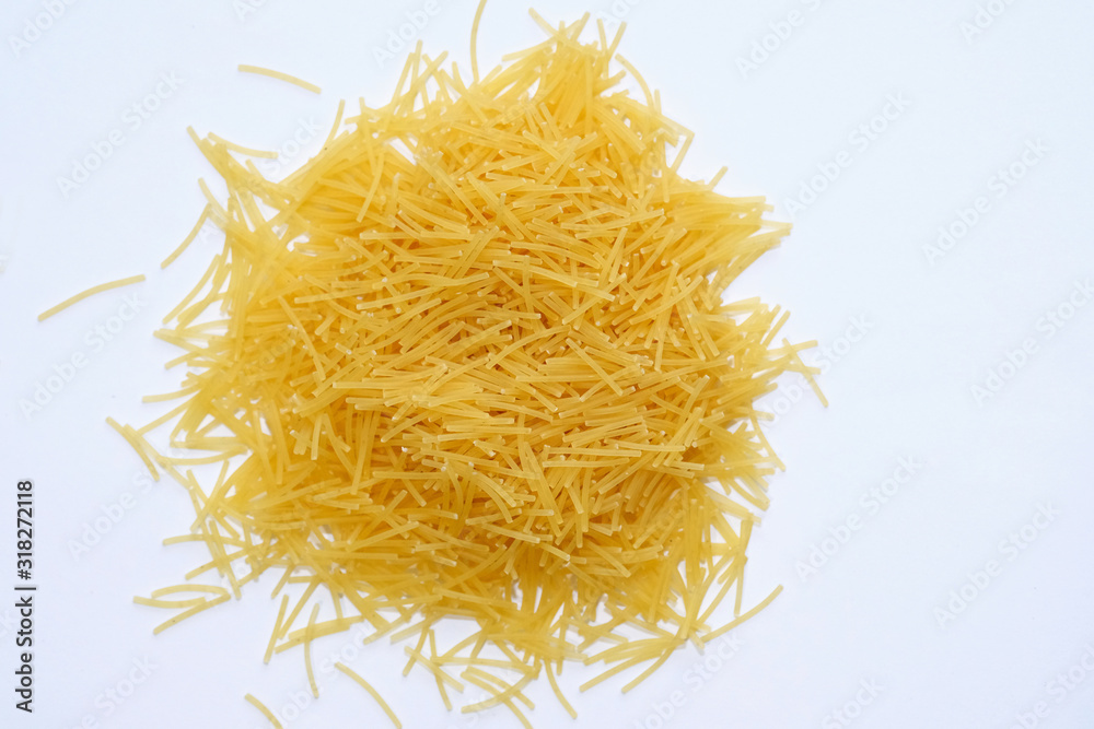 Raw egg vermicelli scattered on a white background. Thin noodles top view. Durum wheat pasta.