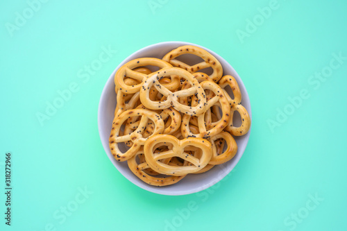 Salted pretzel in white saucer, stock photo
