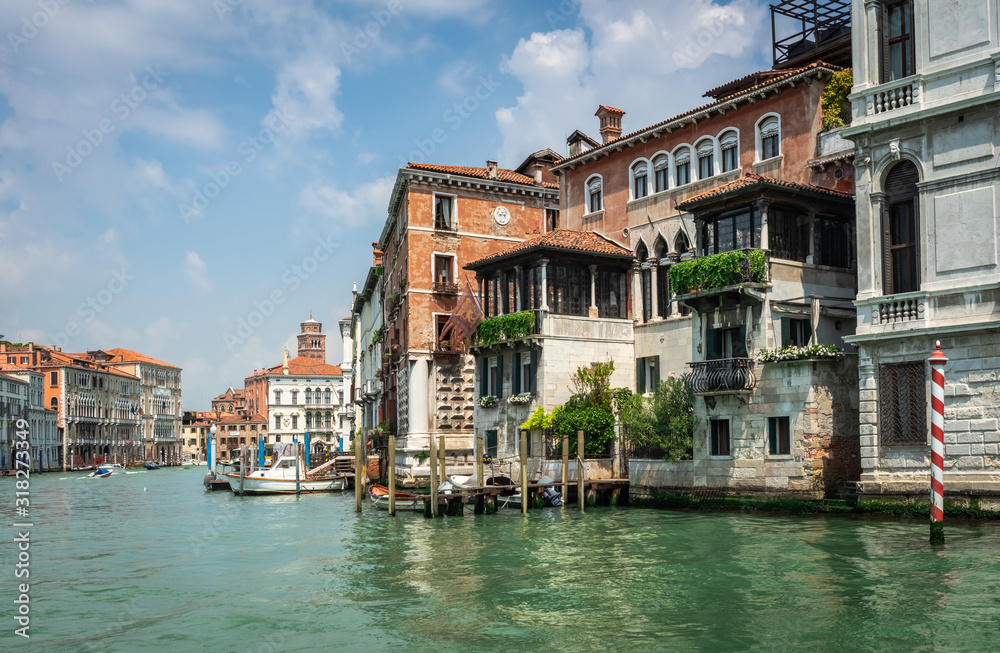 Panorama of Venice. Venetian Canals and gondolas, embankment, bridges, and colorful buildings. Authentic Palazzo. Architecture of an old European city.