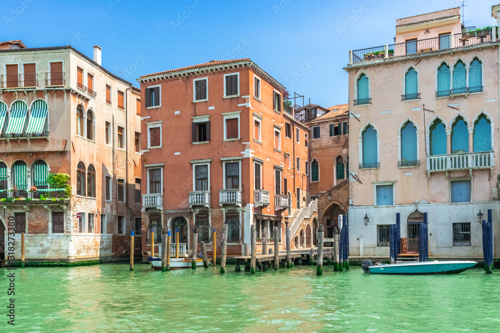 Venice, Italy. View of Venice from the Grand Canal. Venetian old colorful buildings against blue sky and white clouds. Boat trip through the canals of Venice. Vacation in Europe concept.