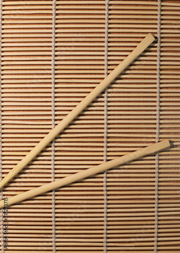 sushi sticks on the background of a sushi Mat