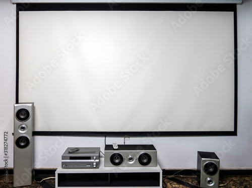 Home cinema. Large white screen home theater system with stereo