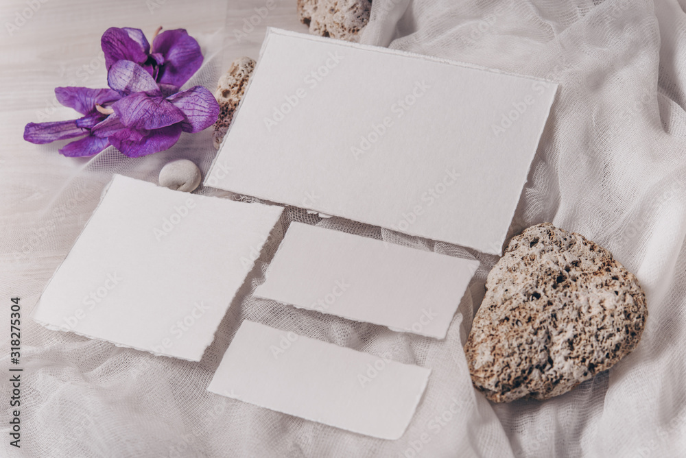 Wedding invitation mockup with orchid, papers on white textile background. Top view, flat lay. Wedding stationary. Perfect for presentation of your invitation, menu, greeting cards Wedding invitation mockup with orchid, papers on white textile background. Top view, flat lay. Wedding stationary. Perfect for presentation of your invitation, menu, greeting cards