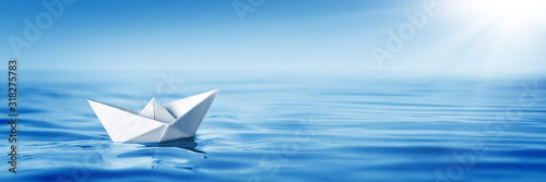 Small White Paper Boat In Big Ocean With Blue Sky And Sunshine - Business Opportunity/Vision Concept