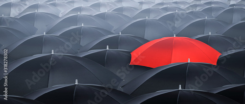 Different and standing out of the crowd umbrella. Concept of leader.