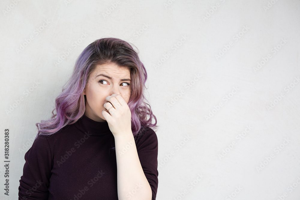 Lovely girl holding breath with fingers on nose Lovely girl holding breath with fingers on nose