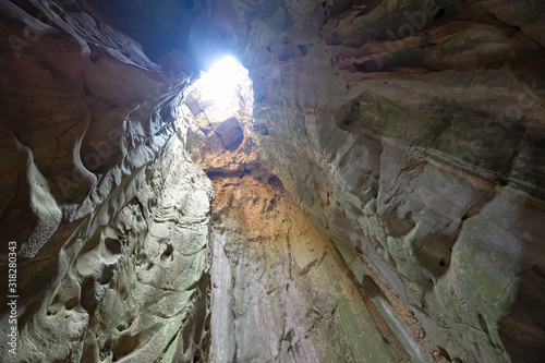 Inside the cave with lighing from above hole