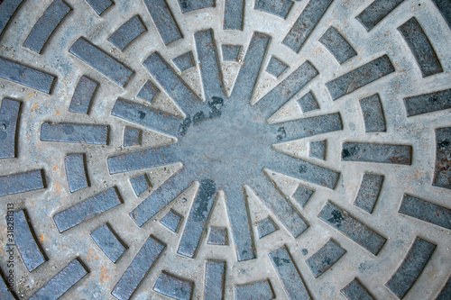 Closeup of manhole cover or pipe cap on the footpath,abstract wallpaper.