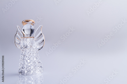 Glass angel with nimbus. Isolated on white, copyspace.