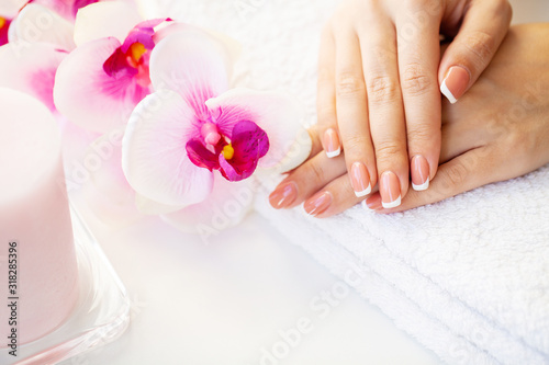 Nails care. Beautiful woman's nails with french manicure, in beauty studio