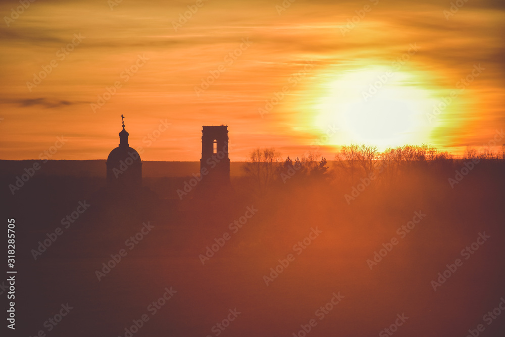 silhouette of church on a sunset background, an abandoned church in field at sunset, church on colorful sunset sky