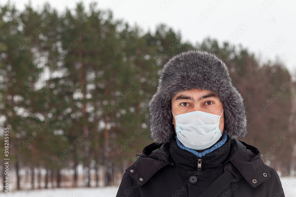Sick man wearing facial mask in winter, outdoor. Russia. Viral diseases, respiratory protection. Sick man wearing facial mask in winter, outdoor. Russia. Viral diseases, respiratory protection.